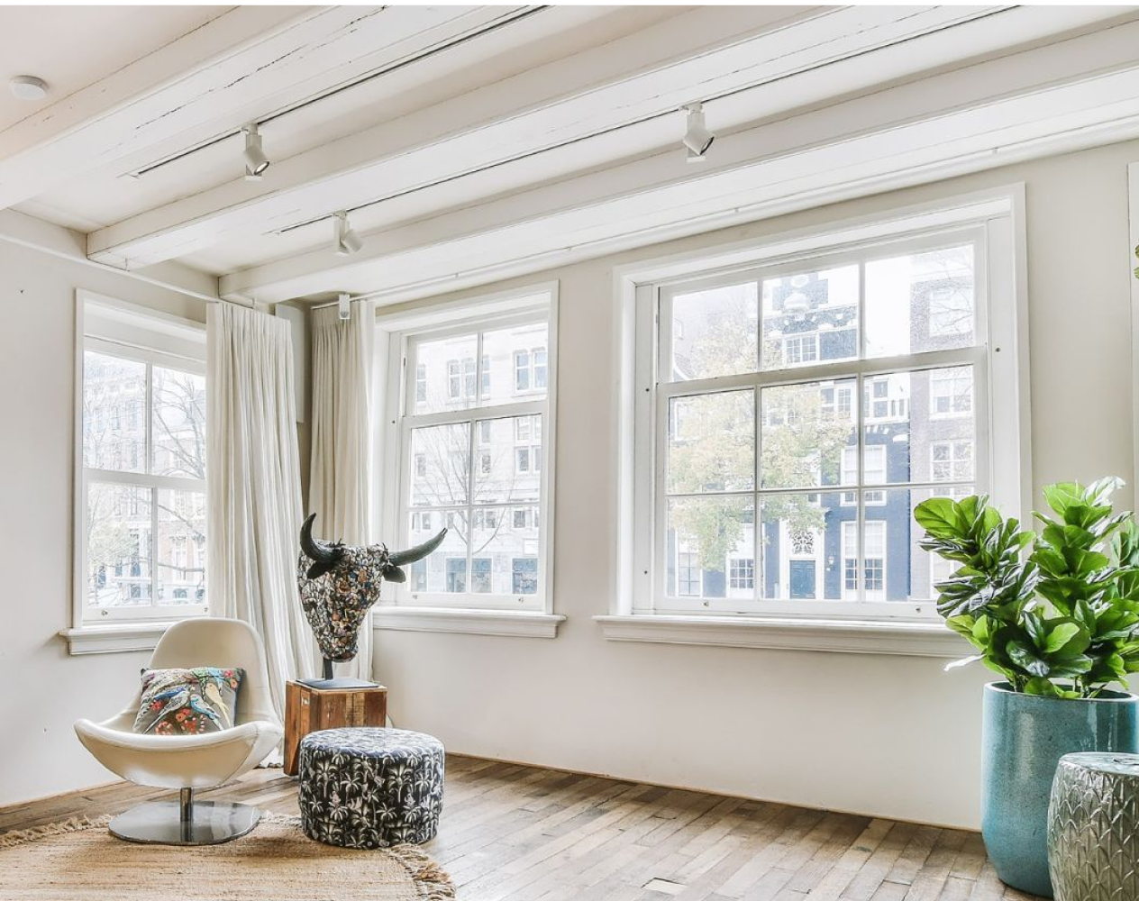 Bright minimalist living area with windows and modern decor